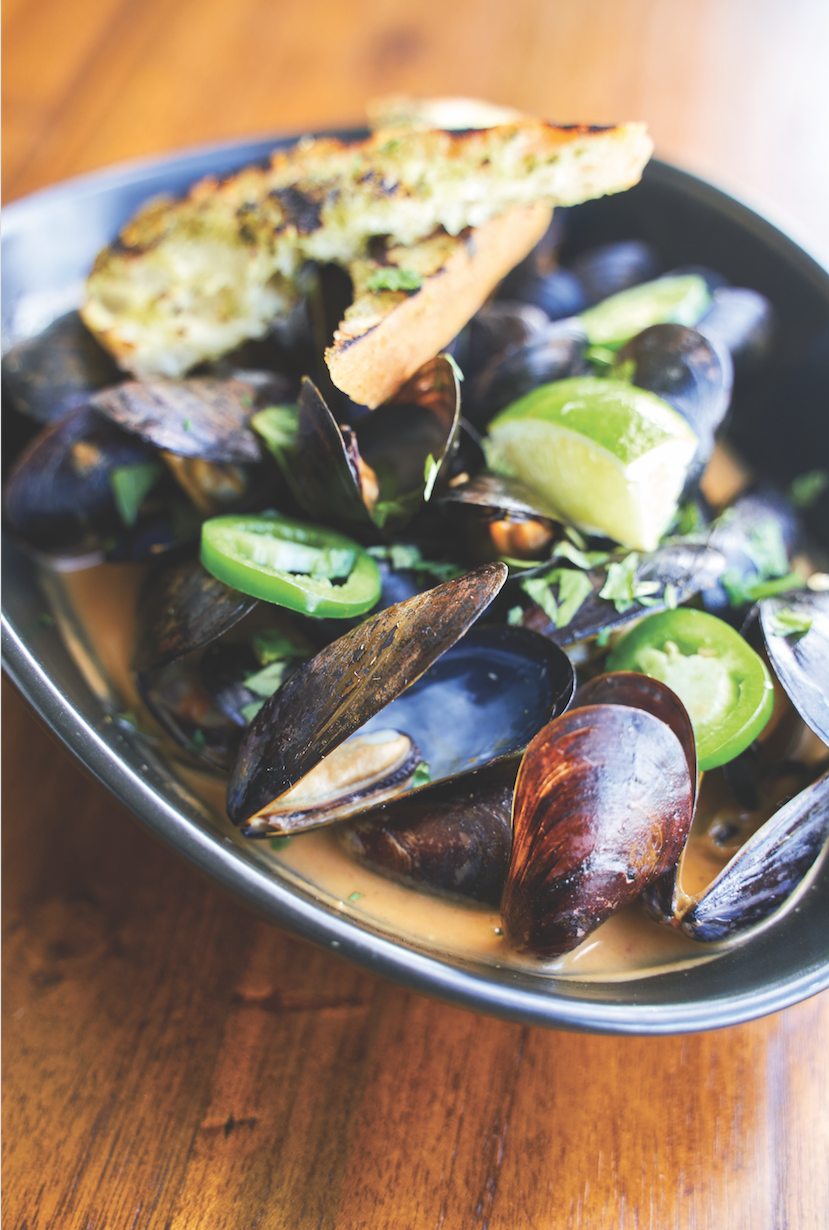 Thai curry mussels with coconut milk, kaffir lime, chili and cilantro. Photography by Wyatt Kostygan.